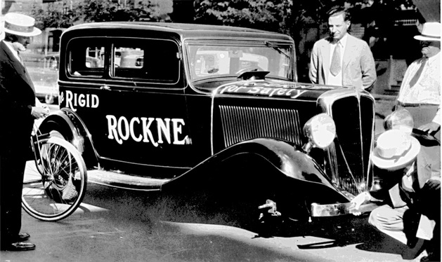Herb (lower right) demonstrates the stability of the “Rigid Rockne” (even on three wheels!) to a skeptical customer outside Babbington Studebaker in the dispiriting days of 1933.
